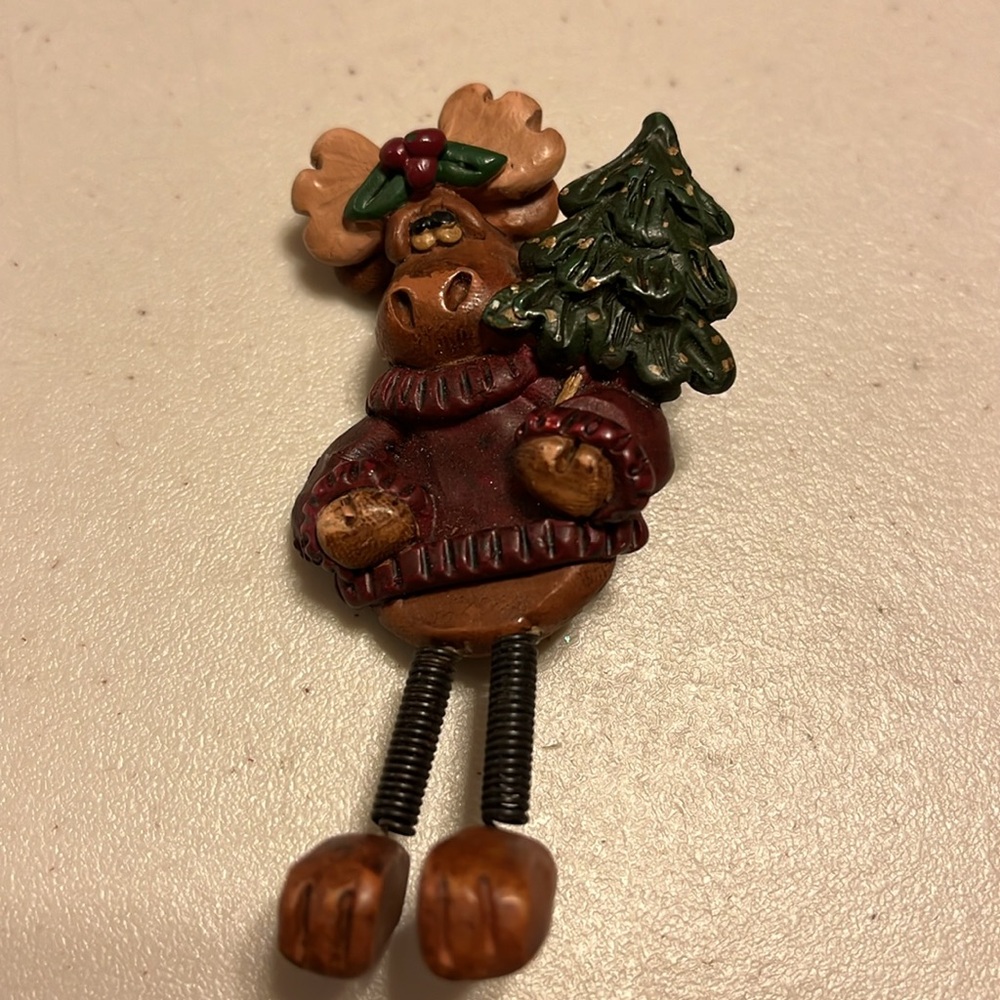 Moose pin broach holding Christmas tree